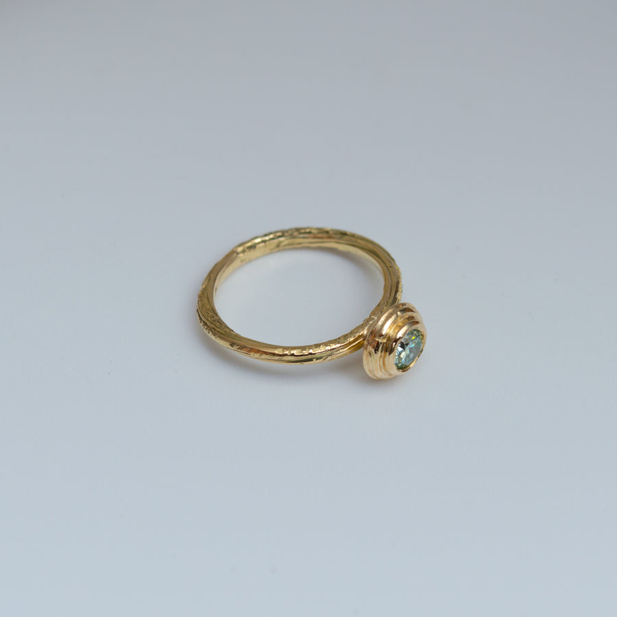 Teal Colour Moissanite Ring in 18ct Yellow Gold. Fold Twist style organic band.